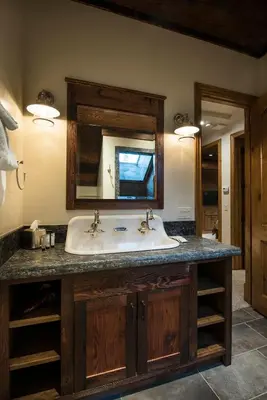 a bathroom with a sink and a mirror at 1R Rustic Retreat in Wawona