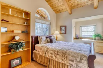 a bedroom with a bed and a large window at Altdorf Vista in Tyrolian Village