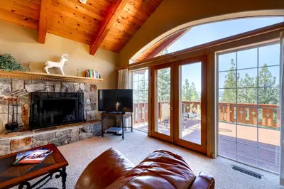 a living room with a fireplace and a large window at Altdorf Vista in Tyrolian Village
