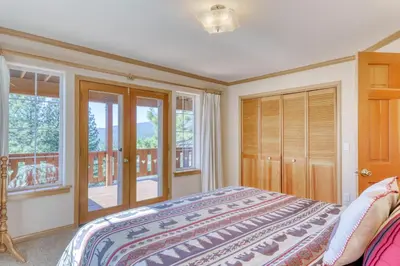 a bedroom with a bed and a balcony at Altdorf Vista in Tyrolian Village