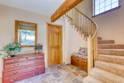 a home with a staircase and a dresser in a room at Altdorf Vista in Tyrolian Village