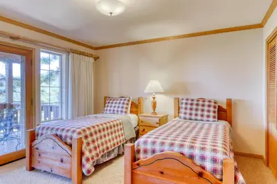 a bedroom with two beds and a window at Altdorf Vista in Tyrolian Village