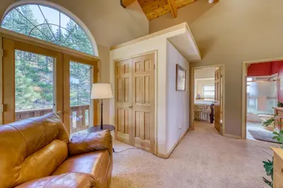 a living room with a leather couch and large windows at Altdorf Vista in Tyrolian Village