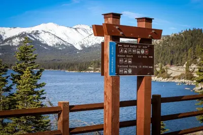 a sign on a fence next to a lake at Altdorf Vista in Tyrolian Village