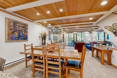 a dining room with a wooden table and chairs at Brockway Springs #36 in Kings Beach