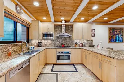 a kitchen with wooden cabinets and a wooden ceiling at Brockway Springs #36 in Kings Beach