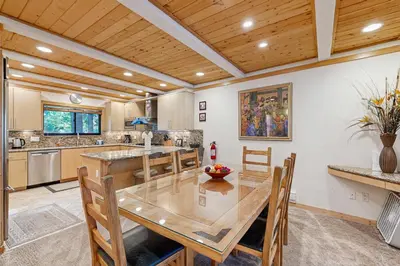 a kitchen with a large wooden table and chairs at Brockway Springs #36 in Kings Beach