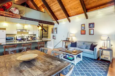 a living room with a table and a couch at Casa del Lago in Tyrolian Village