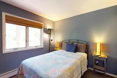 a bedroom with a bed and a window and two lamps at McCloud 137 in Incline Village