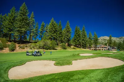 a golf course with a golf cart on a green at McCloud 137 in Incline Village