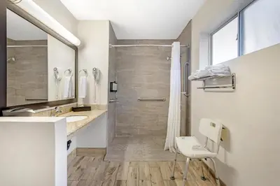 a bathroom with a shower and a sink at Best Western Kettleman City Inn & Suites in Kettleman City