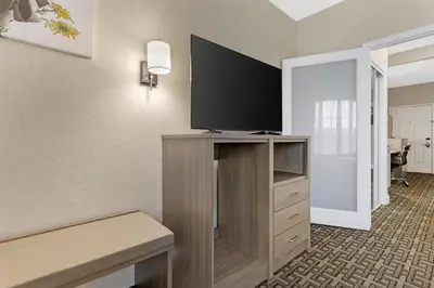a room with a flat screen tv on a entertainment center at Best Western Kettleman City Inn & Suites in Kettleman City