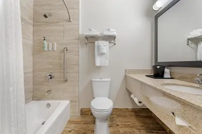 a bathroom with a toilet and a shower and a sink at Best Western Kettleman City Inn & Suites in Kettleman City