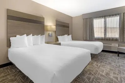a hotel room with two beds and a window at Best Western Kettleman City Inn & Suites in Kettleman City