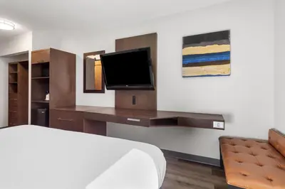 a hotel room with a bed and a tv at SureStay Plus Hotel by Best Western Mammoth Lakes in Mammoth Lakes