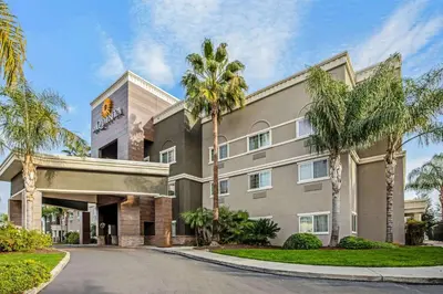a building with palm trees in front of a street at La Quinta by Wyndham Modesto Salida in Modesto