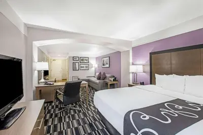 a hotel room with a large bed and a desk at La Quinta by Wyndham Modesto Salida in Modesto