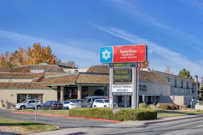 a sign for a shopping center in front of a building at SureStay Plus Hotel by Best Western Reno Airport in Reno