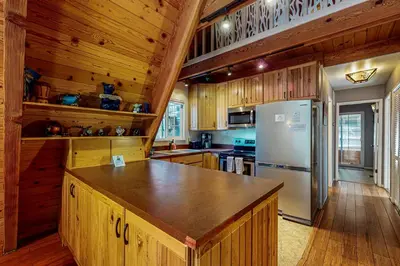 a kitchen with wooden cabinets and a refrigerator at Everness Dawn Retreat* in Mevers