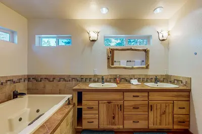 a bathroom with two sinks and a bath tub at Everness Dawn Retreat* in Mevers