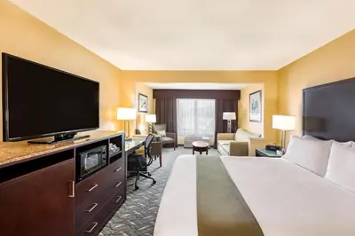 a hotel room with a bed and a flat screen tv at Holiday Inn Express Hotel & Suites San Jose-Morgan Hill by IHG in Morgan Hill