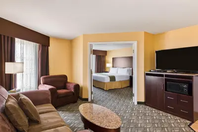 a hotel room with a bed and a television at Holiday Inn Express Hotel & Suites San Jose-Morgan Hill by IHG in Morgan Hill
