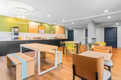 a restaurant with tables and chairs and a counter at Spark by Hilton Modesto in Modesto