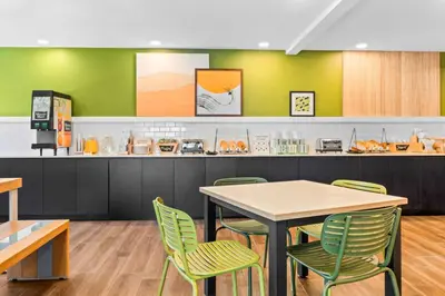 a fast food restaurant with a table and chairs at Spark by Hilton Modesto in Modesto
