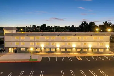 an empty parking lot in front of a white building at Spark by Hilton Modesto in Modesto