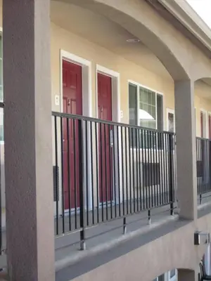 a building with three red doors on a balcony at The Yosemite Inn in Mariposa