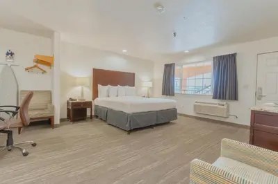 a large hotel room with a bed and a desk at The Yosemite Inn in Mariposa