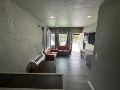 a living room with a couch and a table at Mountain Trail Lodge and Vacation Rentals in Oakhurst