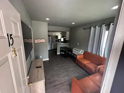 a living room with a couch and a table at Mountain Trail Lodge and Vacation Rentals in Oakhurst