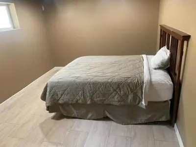 a bedroom with a bed and a wooden floor at Mountain Trail Lodge and Vacation Rentals in Oakhurst
