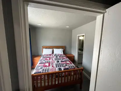 a bedroom with a bed with a quilt on it at Mountain Trail Lodge and Vacation Rentals in Oakhurst