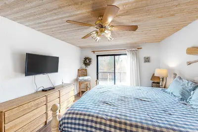 a bedroom with a bed and a ceiling fan at Forest Falls in Shaver Lake
