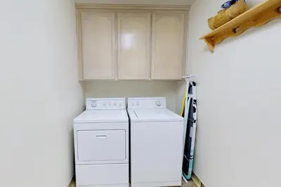 a laundry room with a white washer and dryer at Forest Falls in Shaver Lake