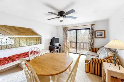 a living room with a table and a couch at Forest Falls in Shaver Lake