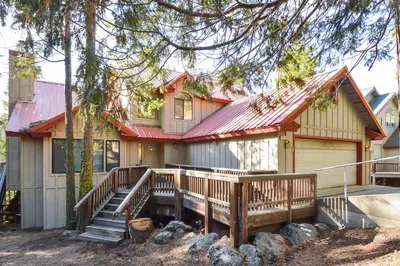 a house with a deck and a house at Forest Falls in Shaver Lake