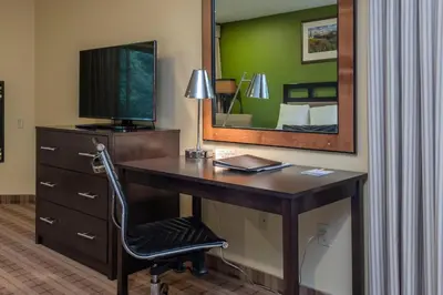 a desk in a hotel room with a mirror at Truckee Donner Lodge in Truckee