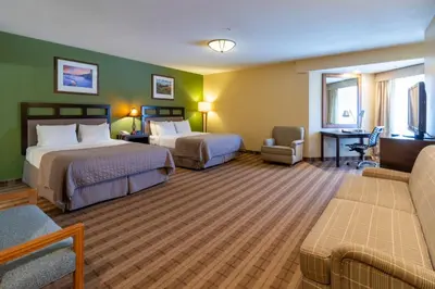 a hotel room with two beds and a couch at Truckee Donner Lodge in Truckee