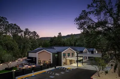 an aerial view of a building with a parking lot at The Inelle, Oakhurst Yosemite, a Tribute Portfolio Hotel in Oakhurst