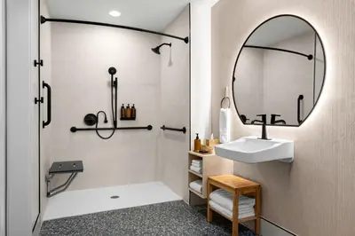 a bathroom with a sink and a mirror at The Inelle, Oakhurst Yosemite, a Tribute Portfolio Hotel in Oakhurst