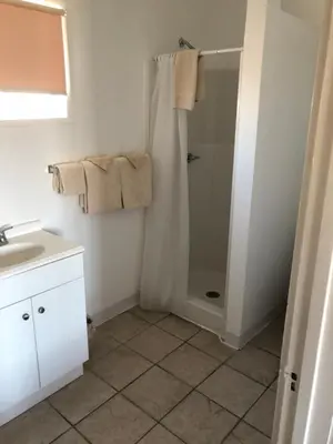 a bathroom with a shower and a sink at Panamint Springs Motel & Tents in Panamint Springs