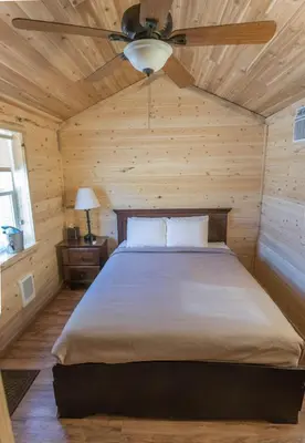 a bedroom with a bed with a ceiling fan at Panamint Springs Motel & Tents in Panamint Springs