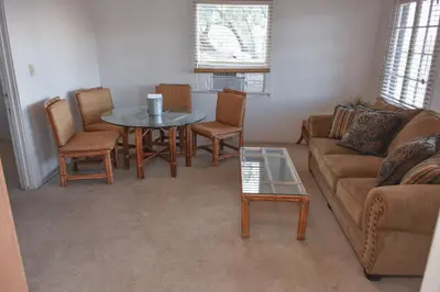 a living room with a couch and a table and chairs at Panamint Springs Motel & Tents in Panamint Springs