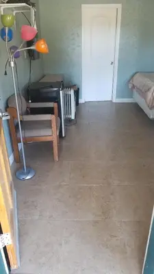 a living room with a tile floor and a lamp at Black Hawk Lodge in Coarsegold