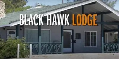 a black hawk house with a black hawk lodge sign on it at Black Hawk Lodge in Coarsegold