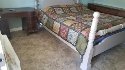 a bedroom with a bed and a side table at Black Hawk Lodge in Coarsegold