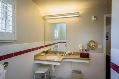 a bathroom with a sink and a mirror at Lions Gate Hotel in Sacramento